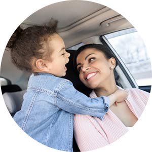 A mother and child happy in a car with a cabin filter